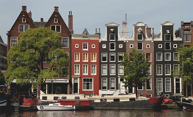 Historic canal houses along an Amsterdam waterfront.